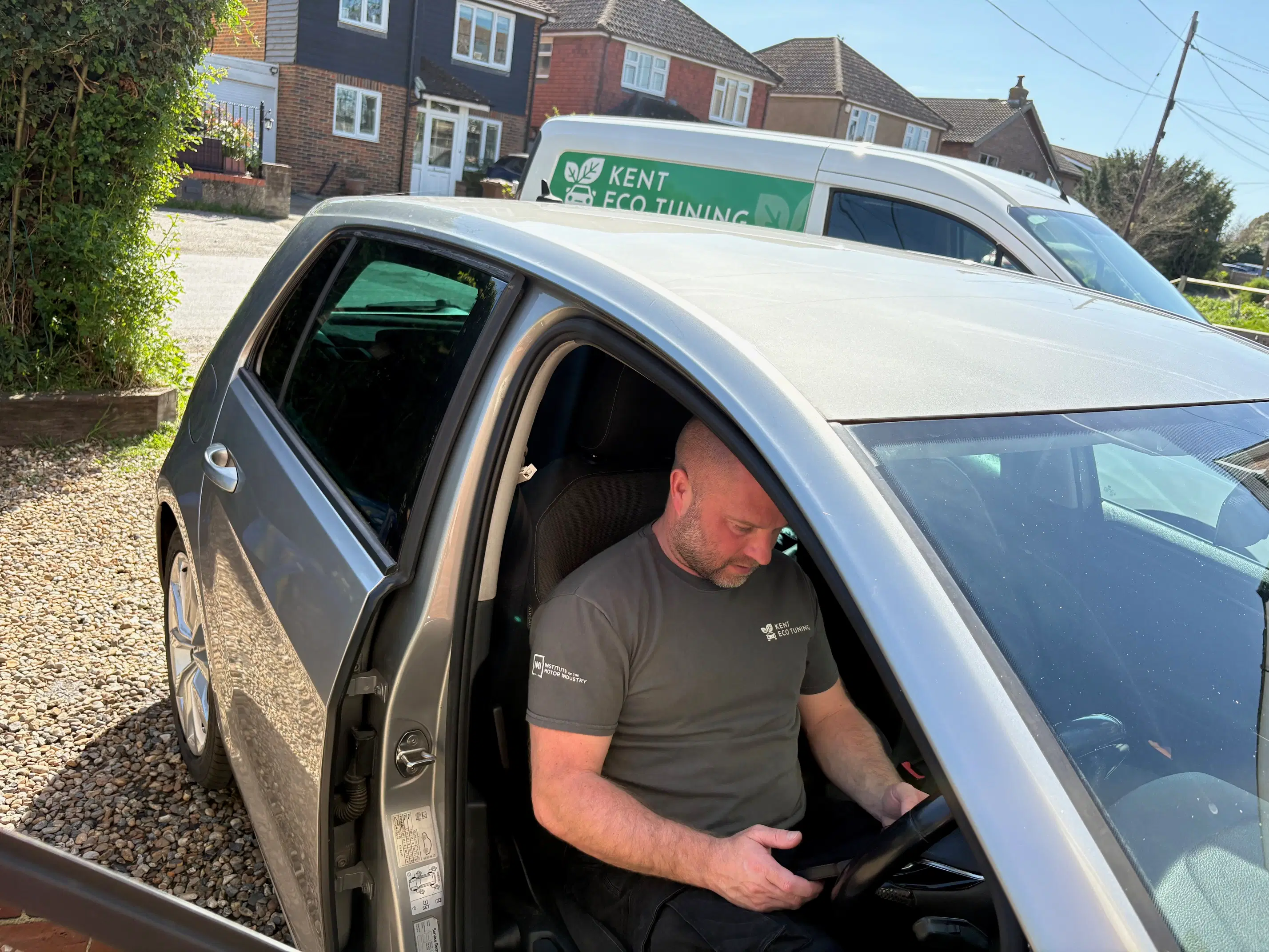 Kent Eco Tuning technician carrying out an in-car diagnostic session beside the branded mobile van