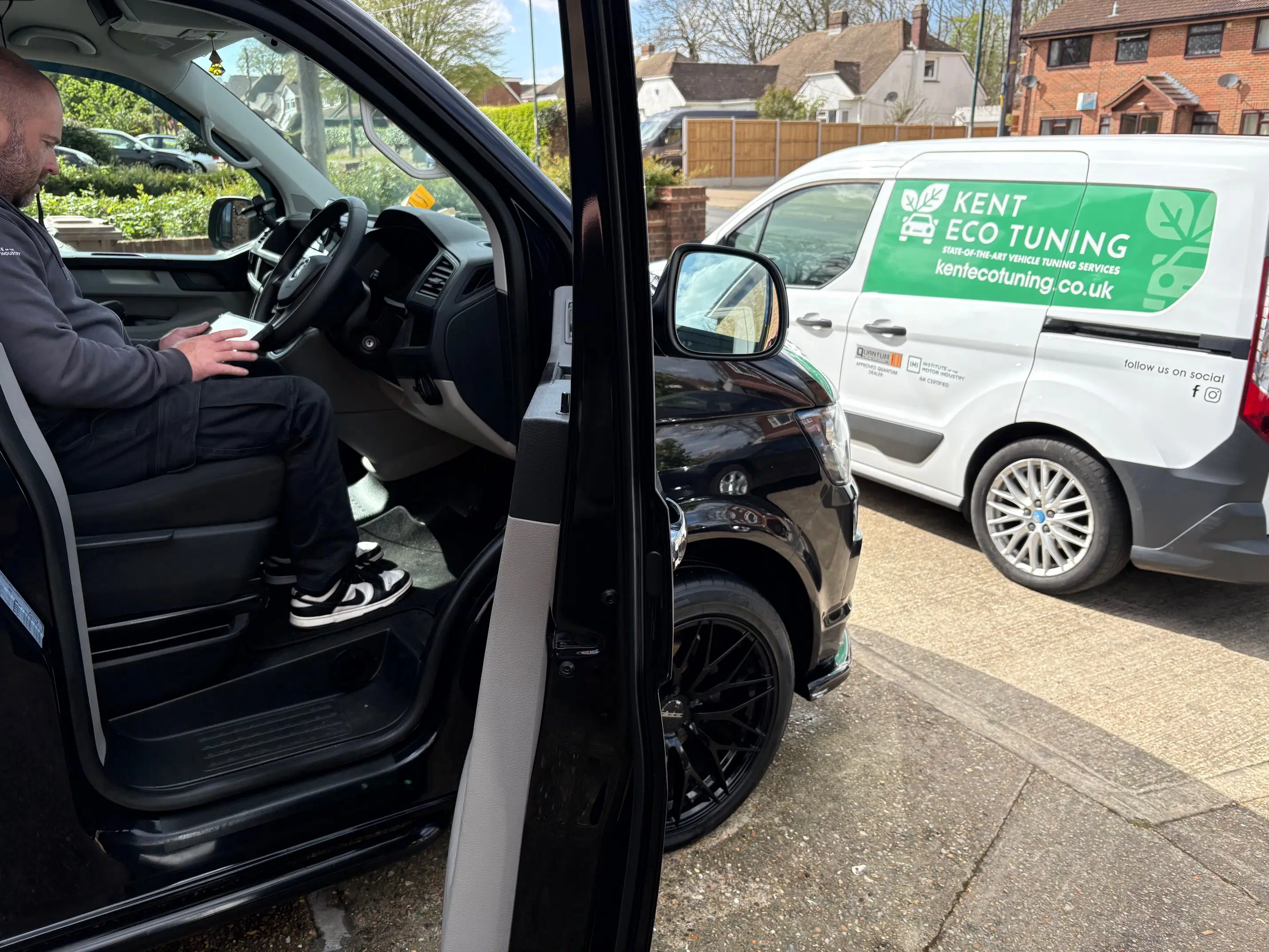 Kent Eco Tuning mobile technician working at a vehicle with the branded van nearby